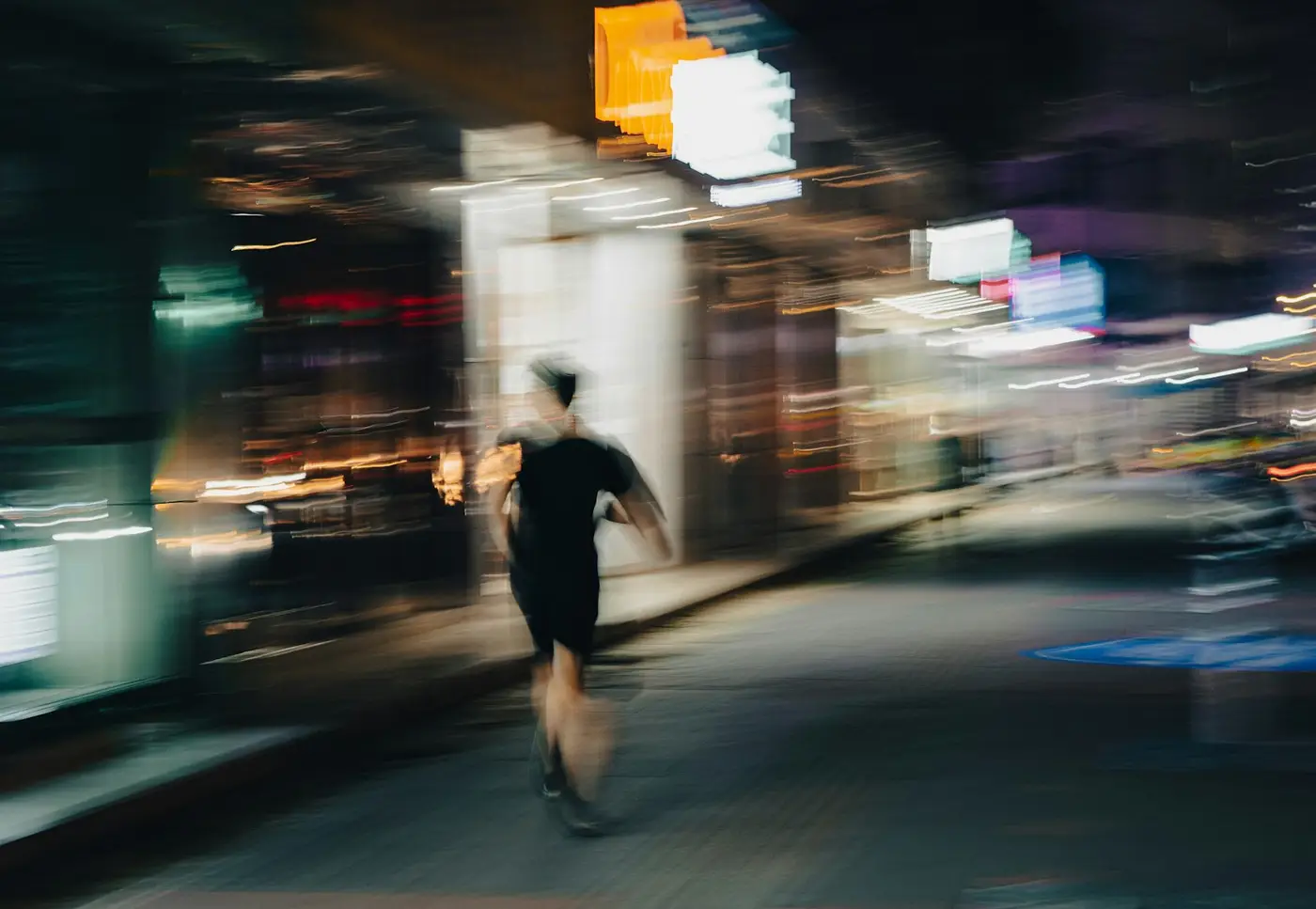 Runner on a city street at night, motion blur