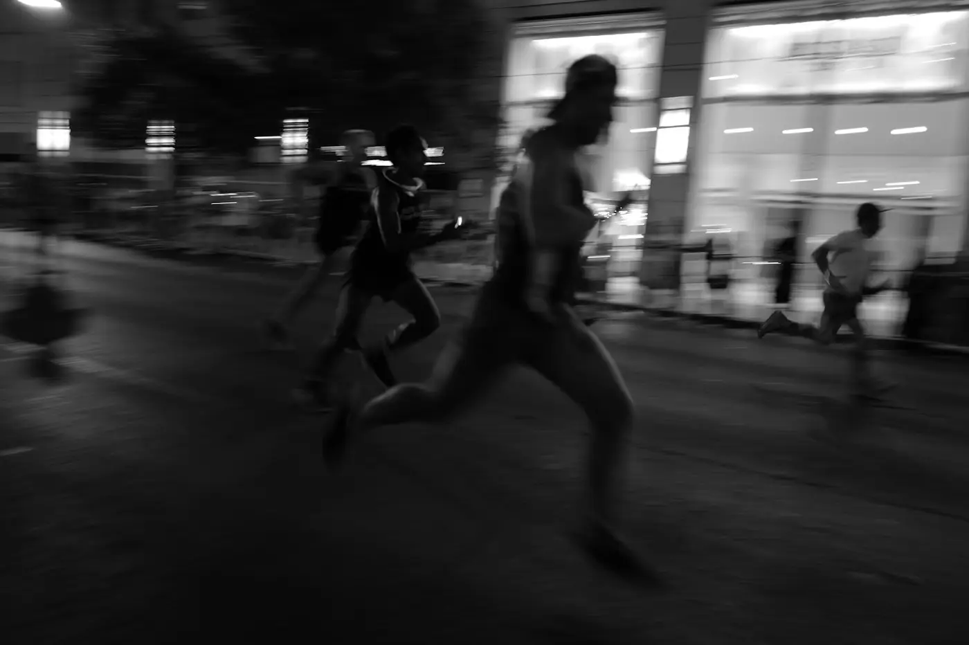 Runners in a night race on a city street