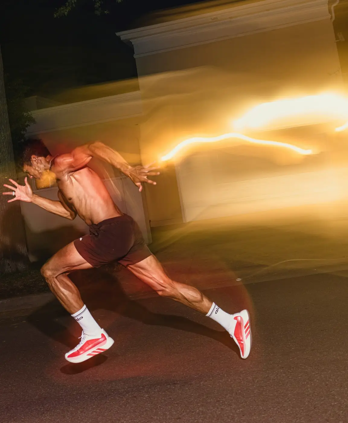 Sprinter at night with light trails